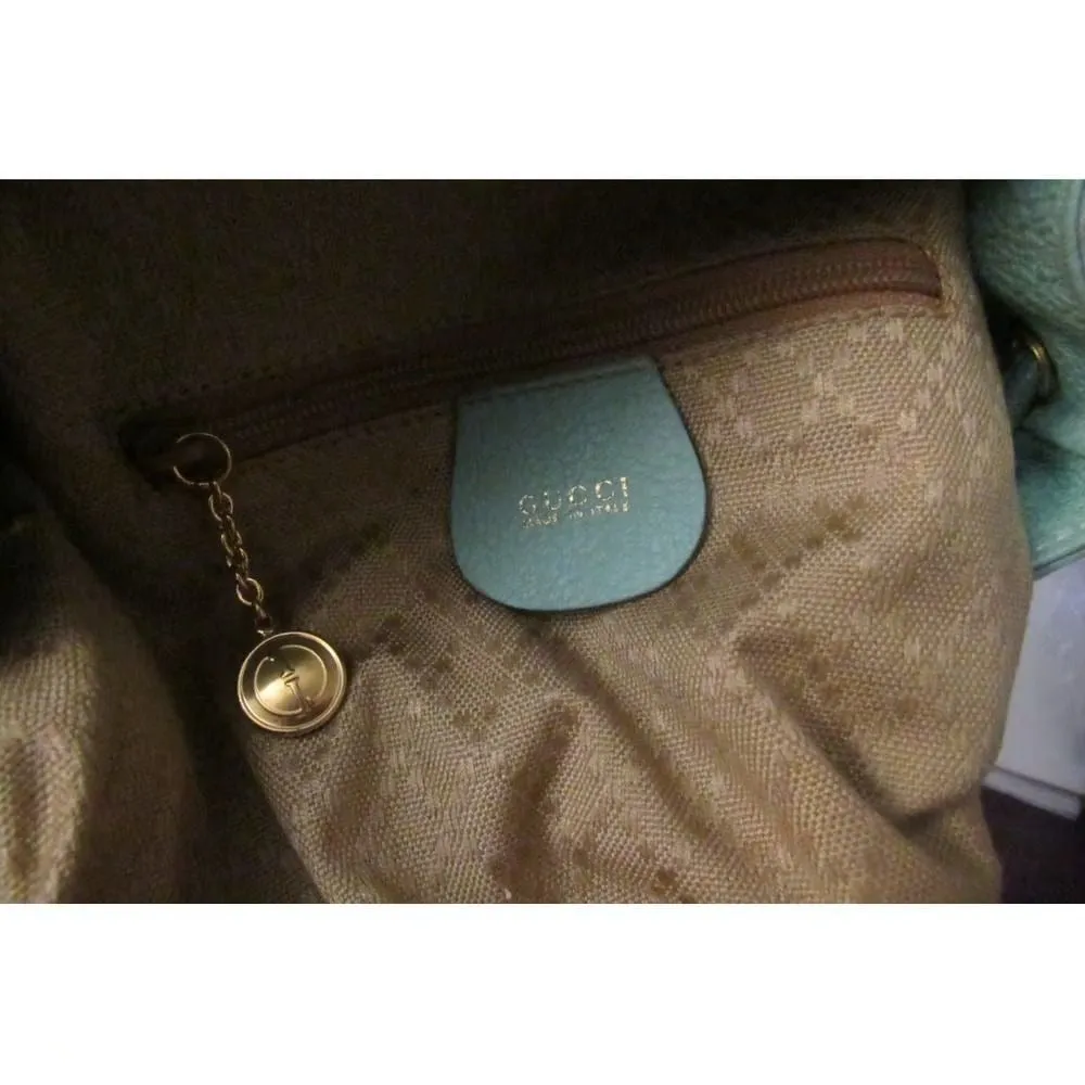 Tom Ford era, Gucci, aqua color, suede and leather, messenger bag/backpack with an exterior pocket, drawstring top closure